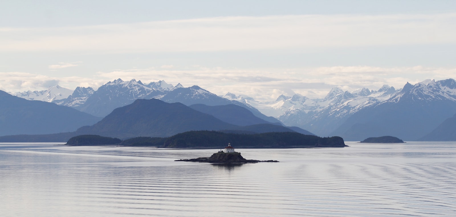 Mountain peaks reflected in a still fjord